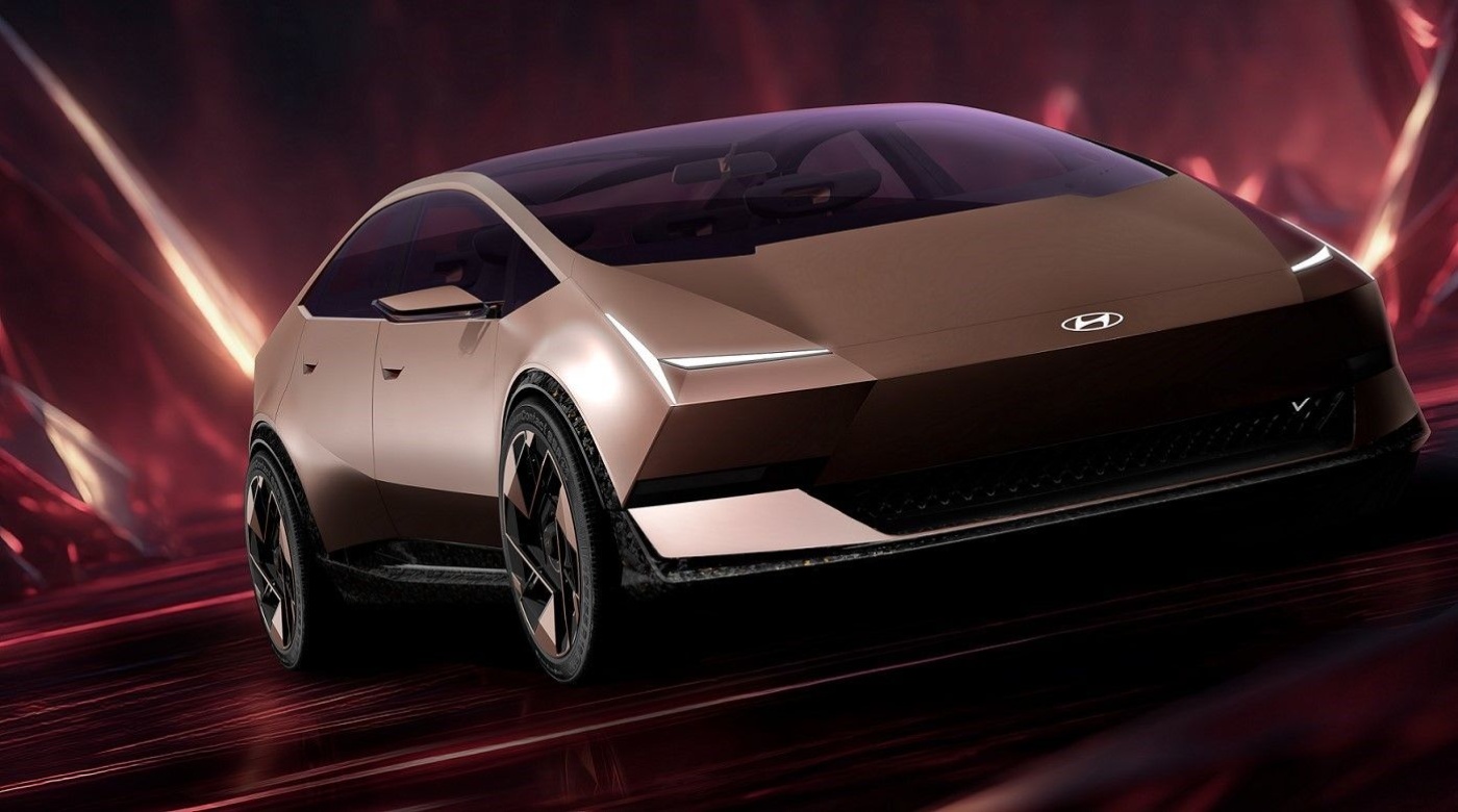 Futuristic Hyundai electric car driving in a red illuminated studio setting.