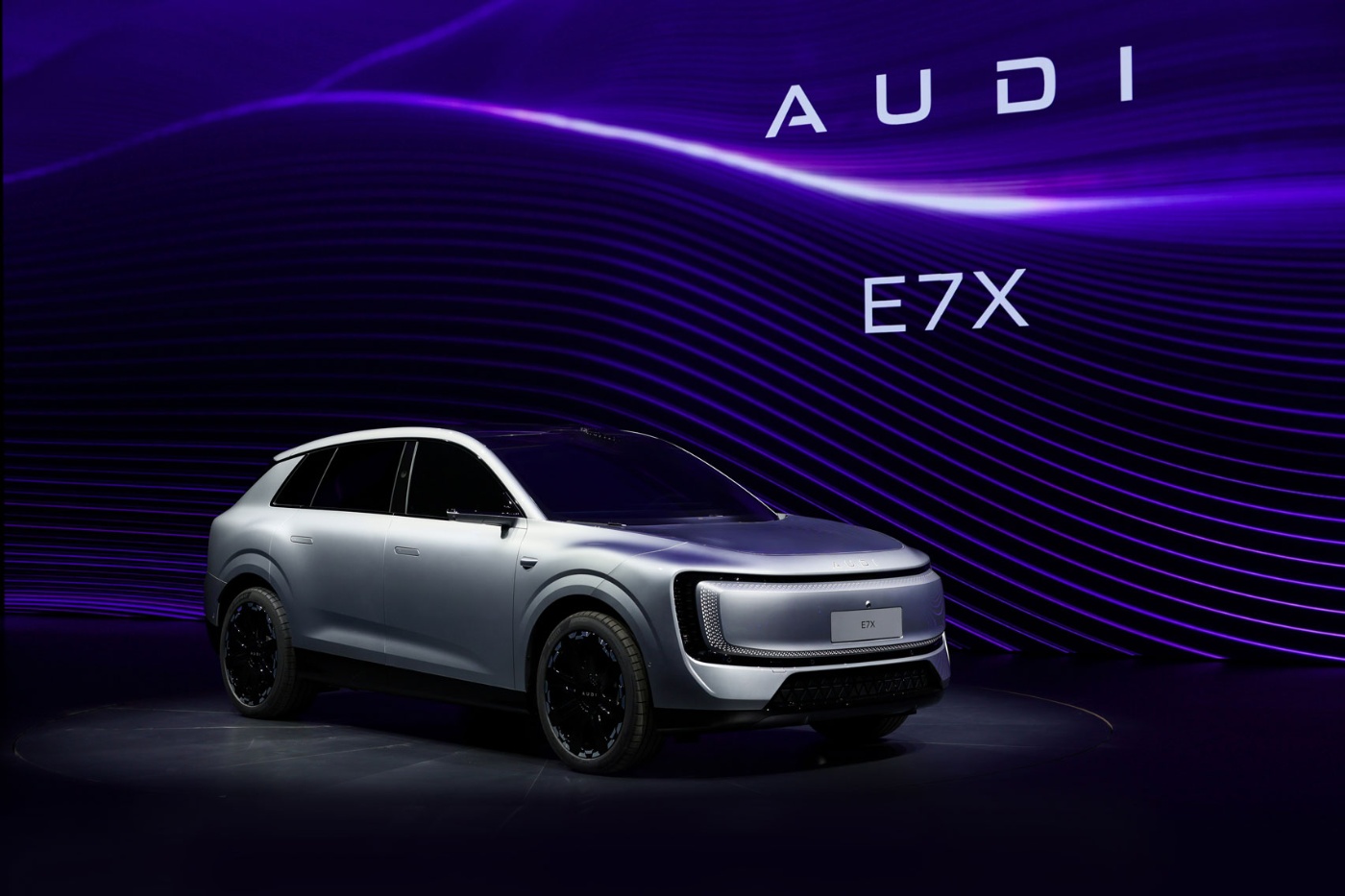 Silberner Audi E7X auf einer Bühne mit lila Lichthintergrund.