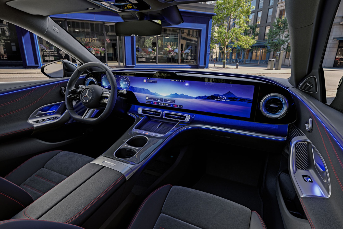 Mercedes-Benz interior with digital dashboard and blue ambient lighting.