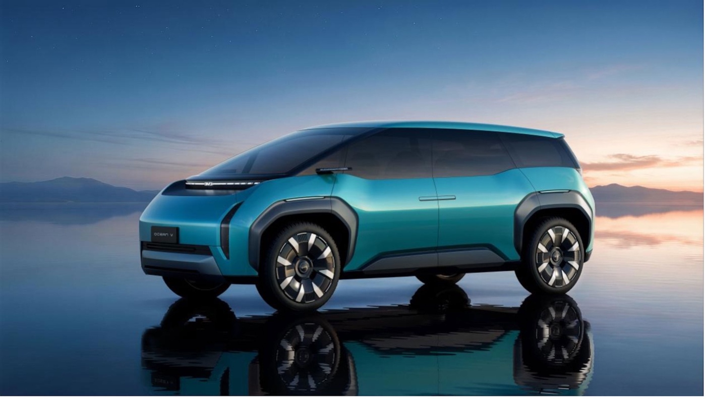 Turquoise SUV on a reflective surface with sunset sky in the background.