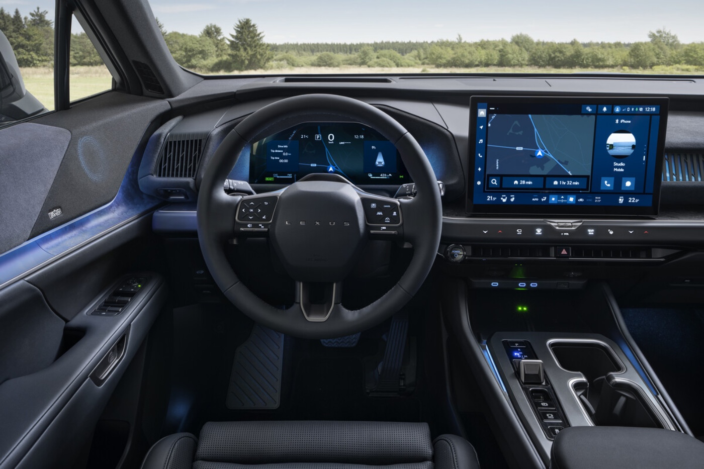 Interior of a Toyota electric SUV with digital cockpit and wide touchscreen.