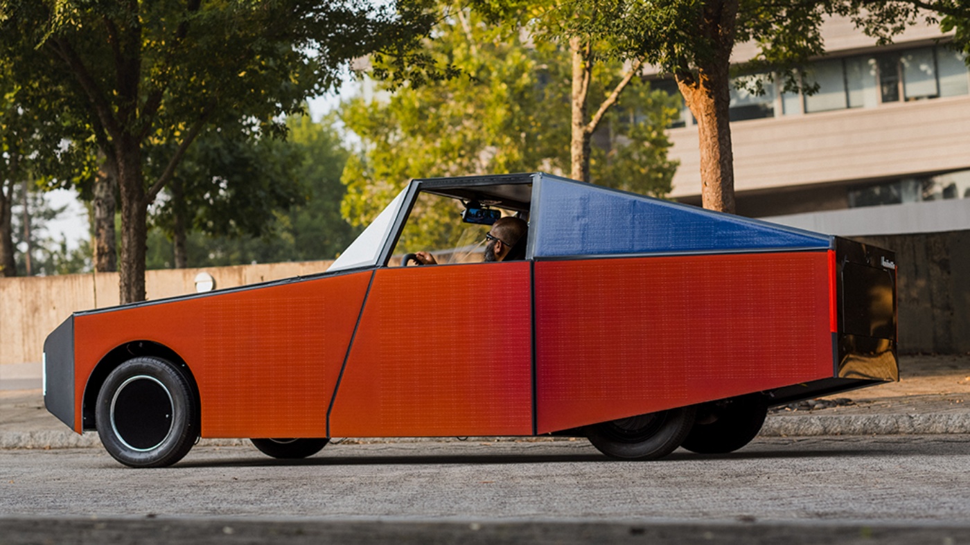Orange autonomous vehicle from Clemson University in side view.