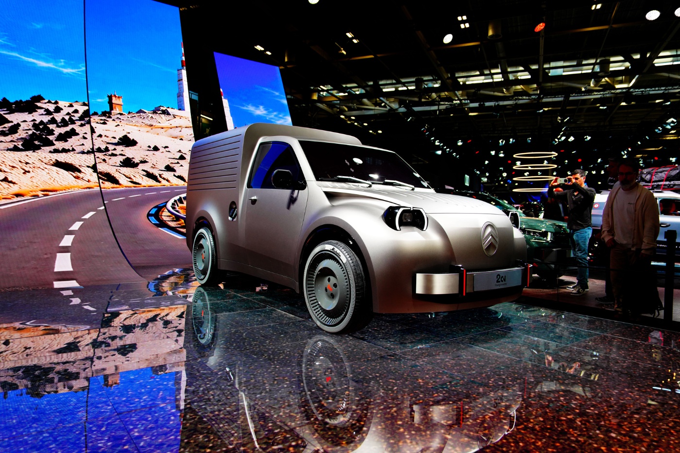 Citroën concept car displayed at the Paris Motor Show with visitors and a desert backdrop.